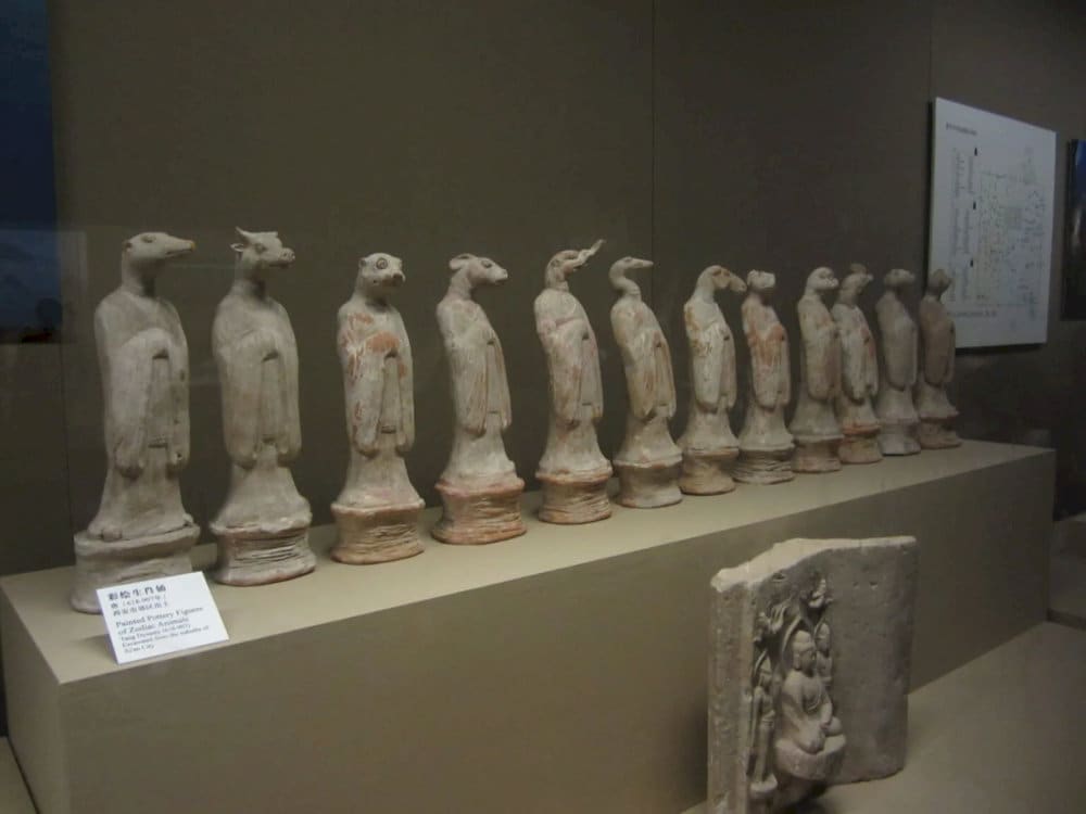 The artifacts on display at the museum include statues, ceramics, and calligraphy